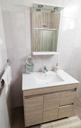 a bathroom with a sink and a mirror at Villa Chloe with the best sunset in Myrties