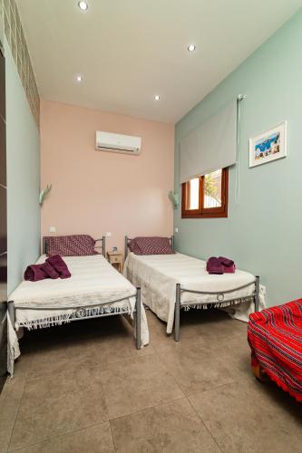 a room with two beds and a window at Villa Chloe with the best sunset in Myrties
