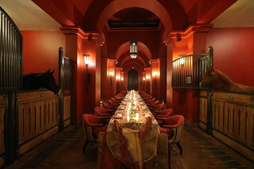a long dining room with a long table and chairs at Selman Marrakech in Marrakesh