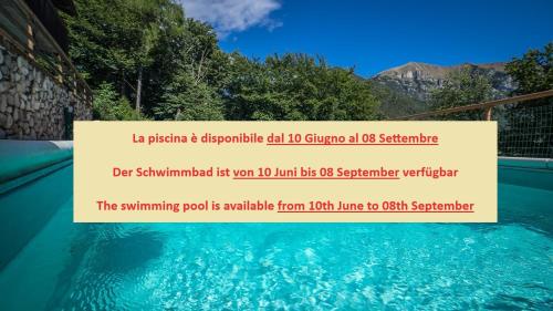 a sign in a swimming pool that reads no swimming pool is available from at Residence Panorama in Molina di Ledro