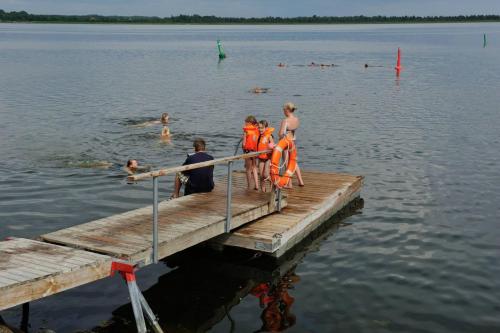 a group of people standing on a dock in the water at Lõunaranna Harbour Accommodation in Simisti