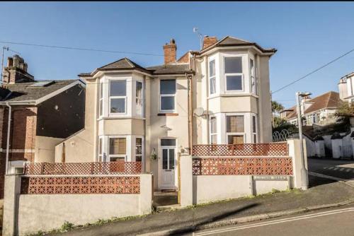 a white house with a fence in front of it at The Boat House Sleeps 4 Pet Friendly in Dawlish