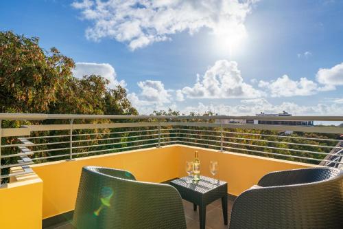a balcony with chairs and a table with a view at Art Deco Central Apartments, Funchal in Funchal