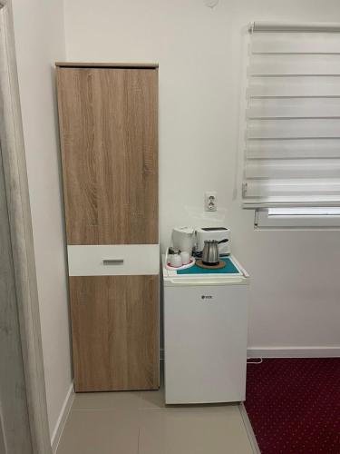a small kitchen with a stove and a refrigerator at ForS Konak Apartments in Belgrade