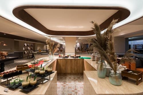 a lobby of a hotel with a buffet at Aston Bintaro Hotel & Conference Center in Kampungutan