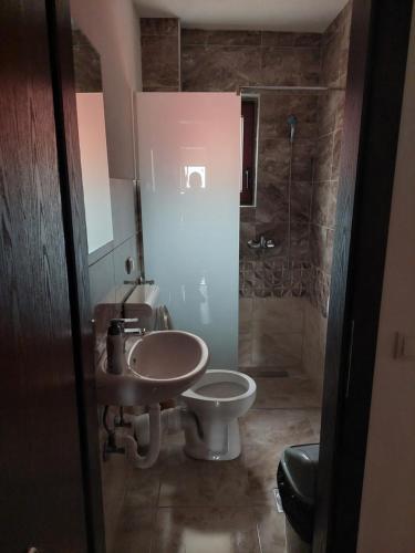 a bathroom with a sink and a toilet at Restoran BMB in Odžak