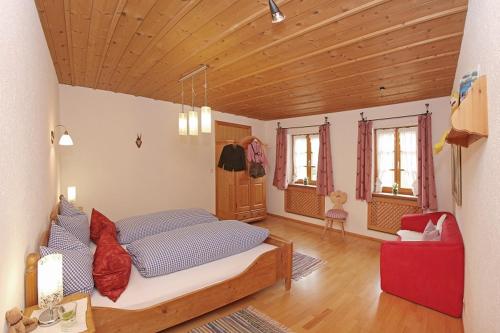 una camera con un grande letto e un soffitto in legno di Ferienwohnung Lechner a Bernau am Chiemsee