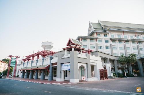 a large white building on the side of a street at Wangchan Riverview in Phitsanulok
