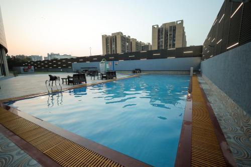 a large swimming pool on top of a building at The World Surat in Surat