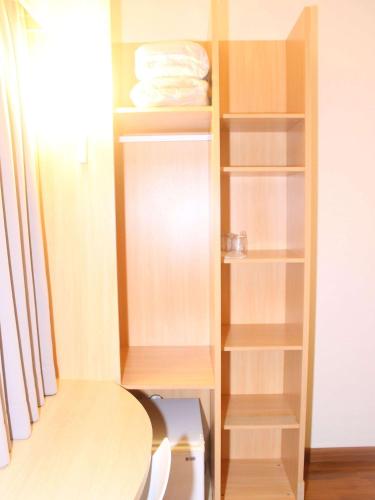 a closet with wooden shelves and a table at Ibis Florianopolis in Florianópolis