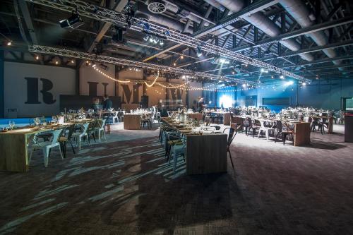 a large room with tables and chairs in it at Titanic Hotel Liverpool in Liverpool