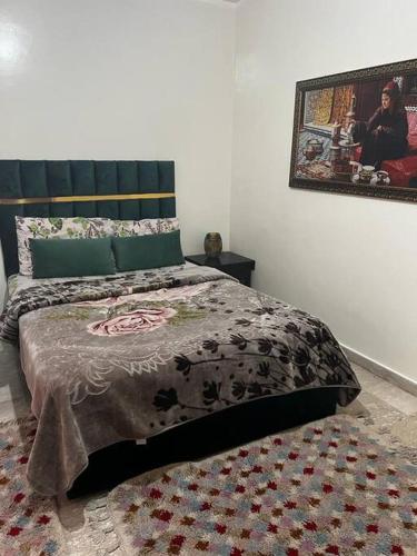 a bedroom with a bed with a blanket and a rug at Beautiful apartment in the city center in Casablanca