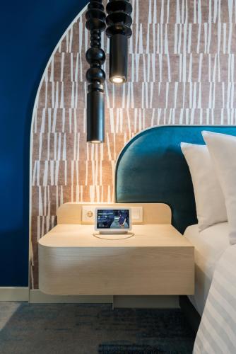 a desk with a laptop on it in a bedroom at Aston Bintaro Hotel & Conference Center in Kampungutan