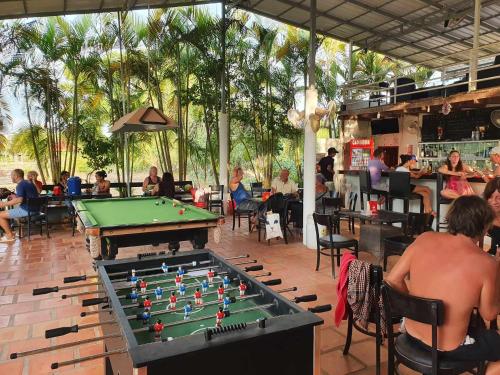 a pool table in a bar with people sitting at Bohemiaz Resort and Spa Kampot in Kampot