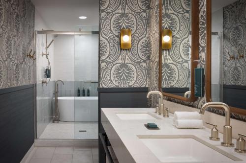 a bathroom with two sinks and a shower at DoubleTree Suites by Hilton Lexington in Lexington