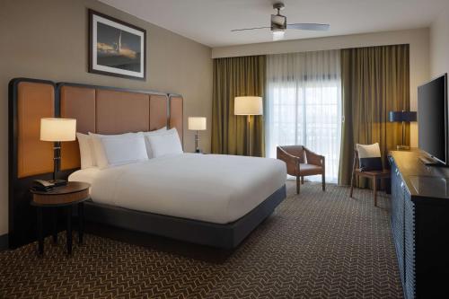 a hotel room with a large bed and a television at DoubleTree Suites by Hilton Lexington in Lexington