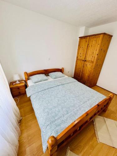 a bedroom with a wooden bed in a room at Apartman Latice in Tomislavgrad