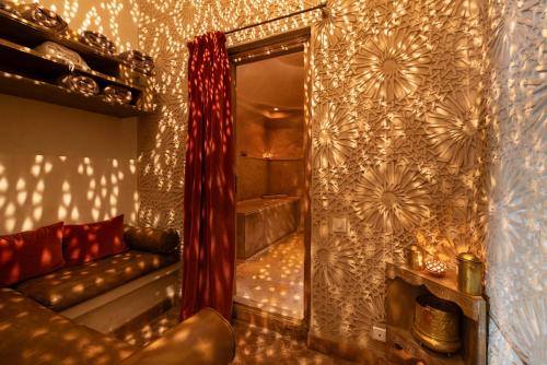 a mirror in a room with a couch in front of a wall at La Villa Nomade in Marrakech