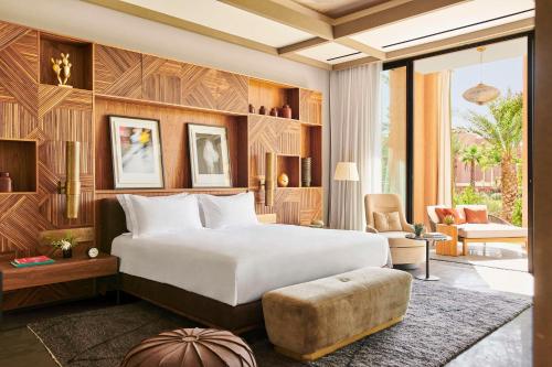a bedroom with a large bed and a living room at Park Hyatt Marrakech in Marrakech