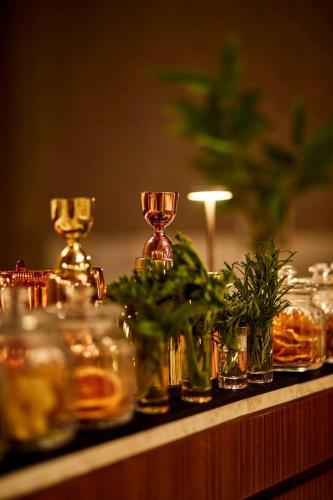 a table with glasses and plants on a table at Park Hyatt Marrakech in Marrakech