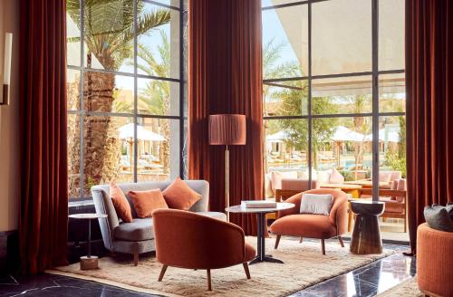 a living room with furniture and a large window at Park Hyatt Marrakech in Marrakech
