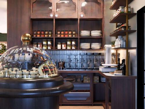 een restaurant met een bar met een glazen display bij Hotel Castel Maintenon in Maintenon