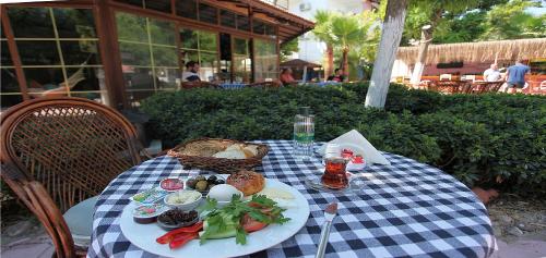 a picnic table with a plate of food on it at London Hotel in Oludeniz