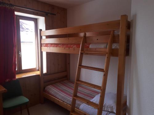 a bunk bed in a room with a ladder at Le Chalet in Lamoura