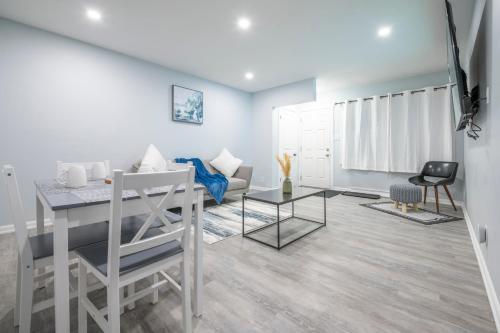 a living room with a table and a couch at Centre Street 2bed Upper Suite - 4408 in Calgary