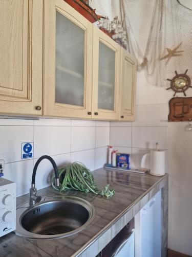 a kitchen counter top with a sink and cabinets at Luxury Apartments Silva with sea view in Trogir