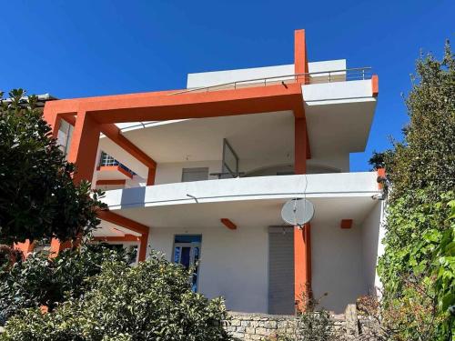 a modern house with orange and white at Apartments Olga in Ulcinj