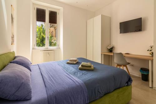 a bedroom with a bed with two towels on it at Domus Eroi in Rome