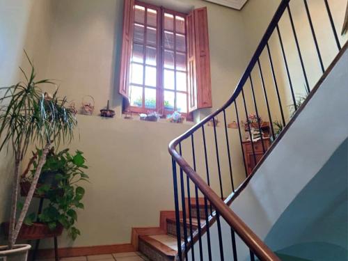 a staircase in a house with a window at CASA RURAL SANCHO in Artajona