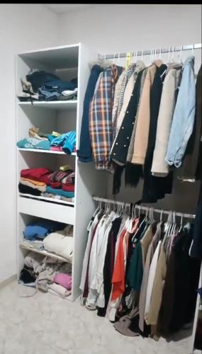 a closet filled with lots of clothes at Piso en Estación de buses in Granada