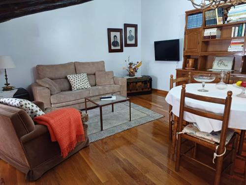 a living room with a couch and a table at CASA RURAL SANCHO in Artajona