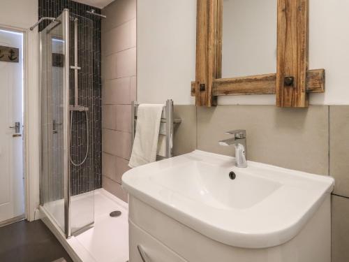 a bathroom with a white sink and a shower at 16 Church Street in Lyme Regis