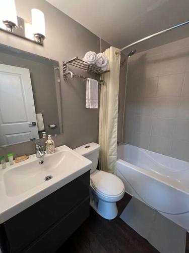 a bathroom with a sink and a toilet and a tub at Dreamy Escape | Cozy & Stylish Stay for Two in London