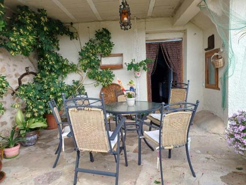 a table and chairs on a patio with plants at CASA RURAL SANCHO in Artajona
