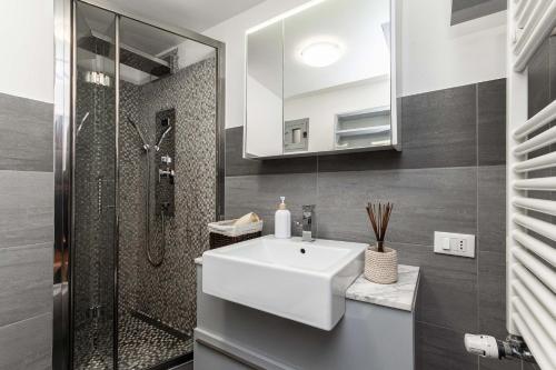 a bathroom with a white sink and a shower at Ethnic Room a few steps to Colombo House and the Shopping Center in Genoa