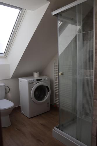 a bathroom with a washing machine and a toilet at SK Apartments in Prešov
