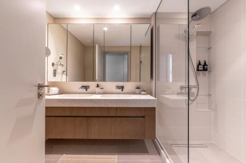 a bathroom with a sink and a shower at 2BR Beachfront Gem with Dazzling Views of the Palm in Dubai