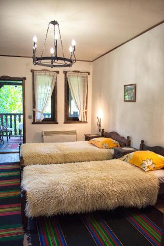 a bedroom with two beds with large furry beds at Milkovata Guest House in Koshov