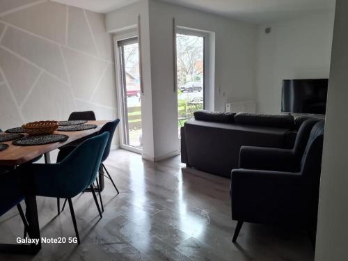 a living room with a couch and a table at Lilias Ruheoase in Pfungstadt