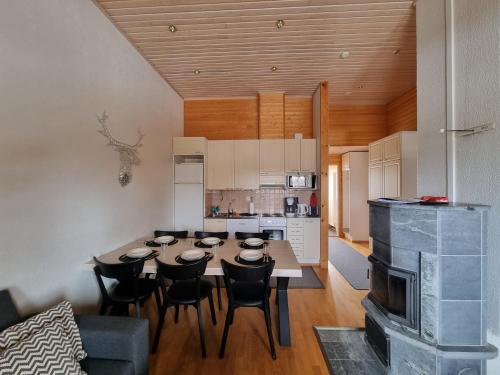 een keuken en eetkamer met een tafel en stoelen bij Kuukkeli Apartments Suite in Saariselkä