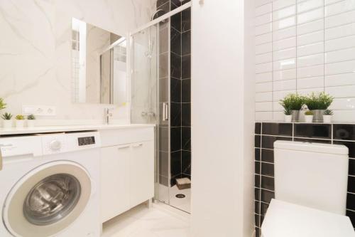 uma casa de banho branca com uma máquina de lavar roupa e um lavatório em Encanto Celestial en Santa Úrsula em Madrid