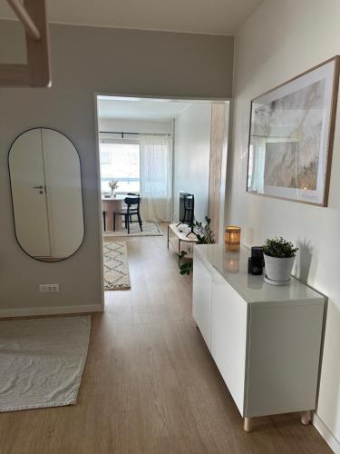 a living room with a mirror and a table at Arctic City Apartment in Rovaniemi