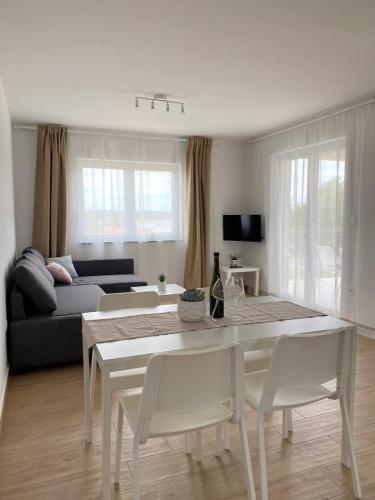 a white table and chairs in a living room at Martina in Rab