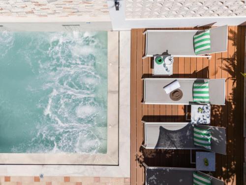 a view of the ocean from the balcony of a room at Eliza Hotel by Panel Hospitality - Formerly Evdion Hotel in Nei Poroi