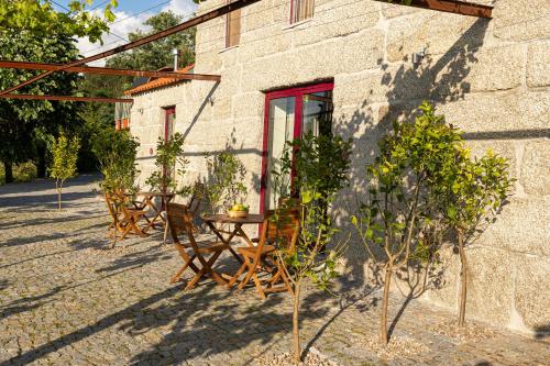 a table and chairs in front of a building at Peso Village in Amarante