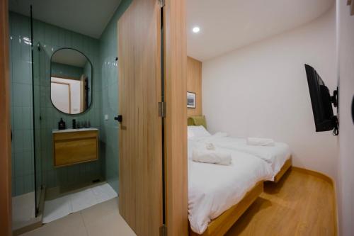 a bathroom with a bed and a shower and a sink at 2 Bed 2 Bath / Luxury / 1 min walk to BTS Asok in Bangkok